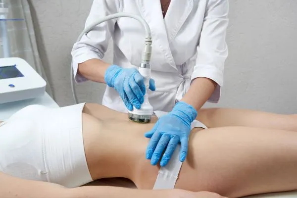 Lost the Weight but Not the Loose Skin? 2 woman having HIFU treatment on her stomach to combat loose skin Ascot following weight loss